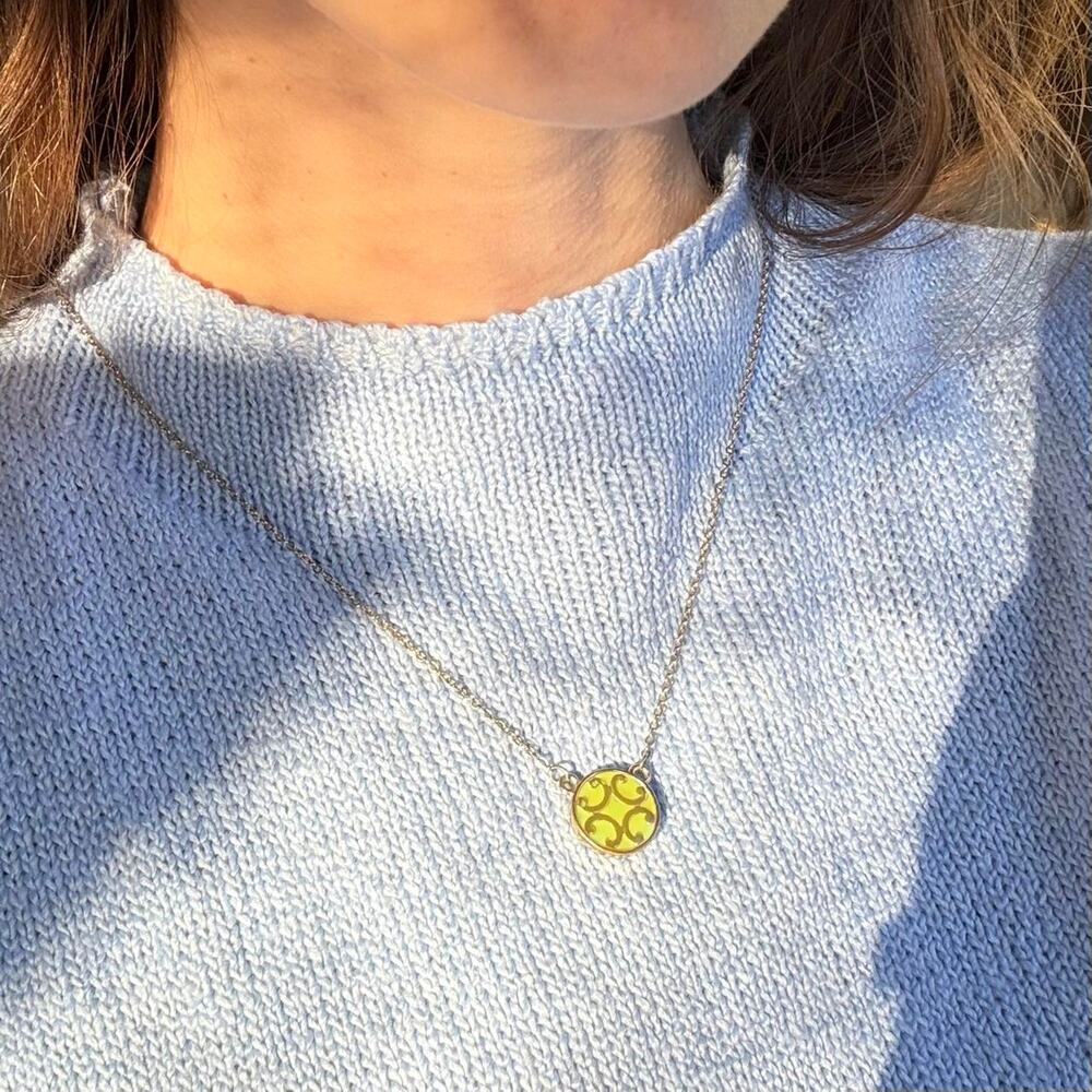 Gold toned necklace with green pendant